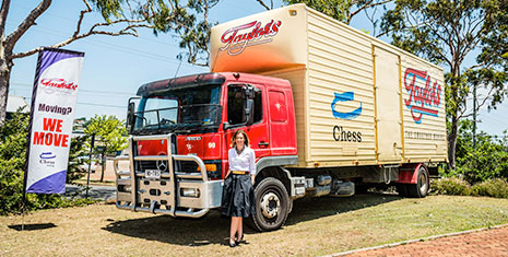 Melissa standing along side their current Taylor's Removalist truck